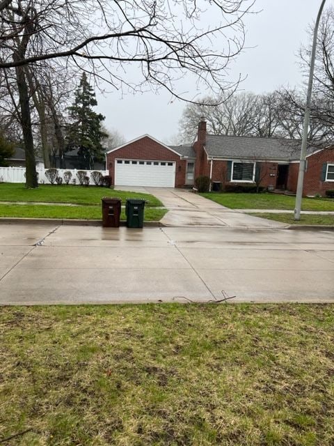 1220 Elford Ct, Grosse Pointe Woods, MI 48236 - view of front of house featuring a chimney, a front yard, and a detached garage