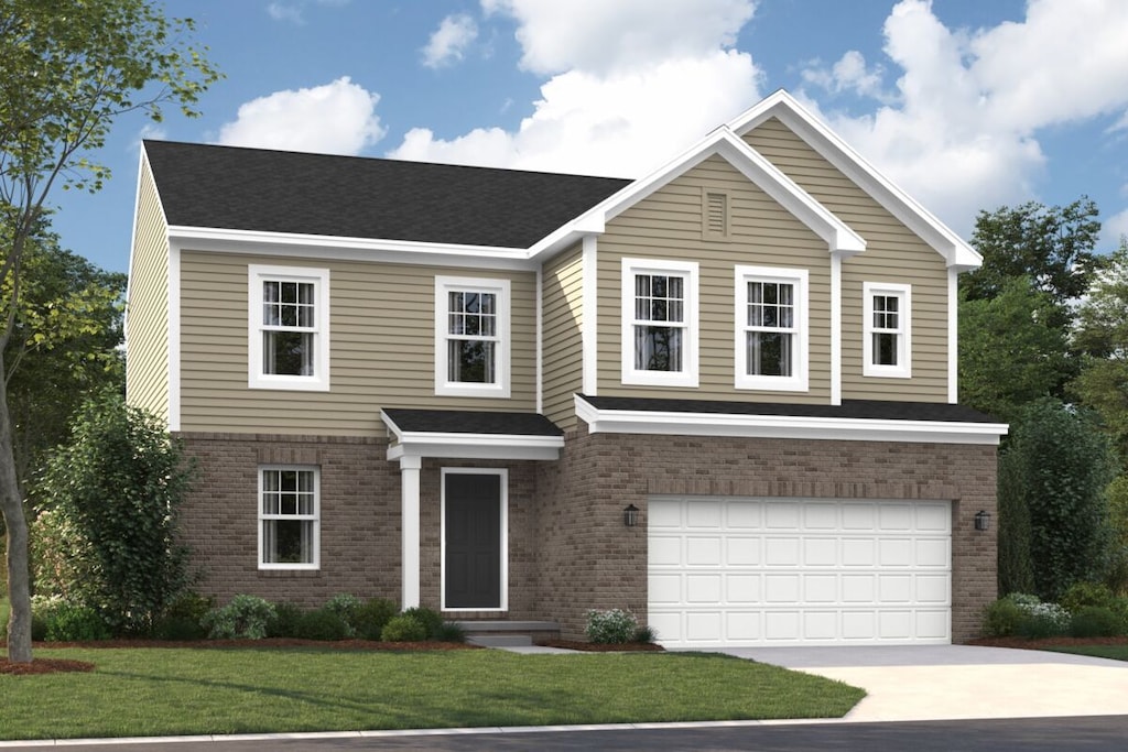 view of front of house with a garage and a front lawn