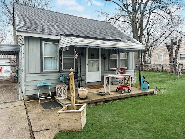 rear view of house featuring a yard