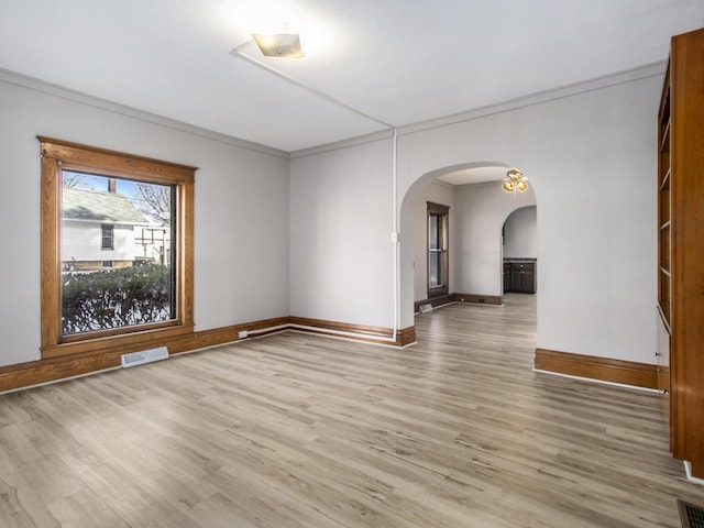 spare room featuring hardwood / wood-style floors and crown molding