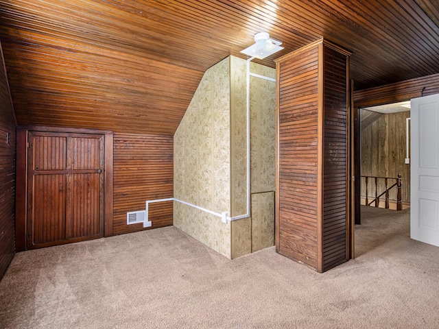 additional living space featuring carpet flooring, wood walls, wooden ceiling, and lofted ceiling