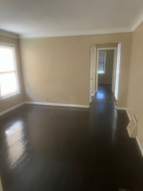 unfurnished room featuring dark wood-type flooring