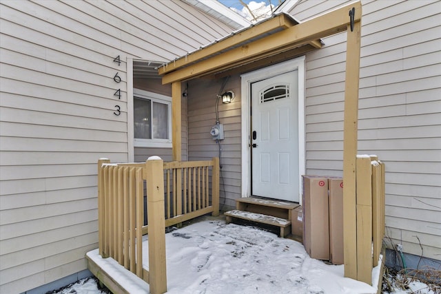 view of snow covered property entrance