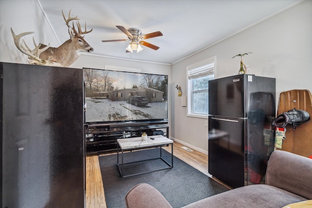 4643 Waldon Rd, Clarkston, MI 48348 - living room with wood finished floors, a ceiling fan, and crown molding