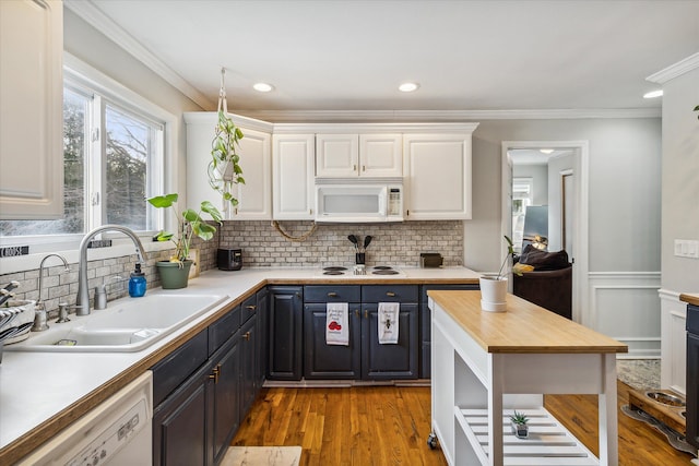 4643 Waldon Rd, Clarkston, MI 48348 - kitchen with white appliances, white cabinets, light wood-style floors, backsplash, and crown molding