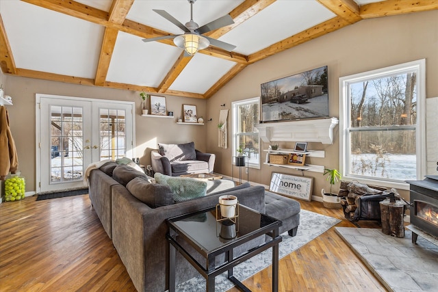 4643 Waldon Rd, Clarkston, MI 48348 - living area featuring a wood stove, a ceiling fan, hardwood / wood-style floors, and french doors