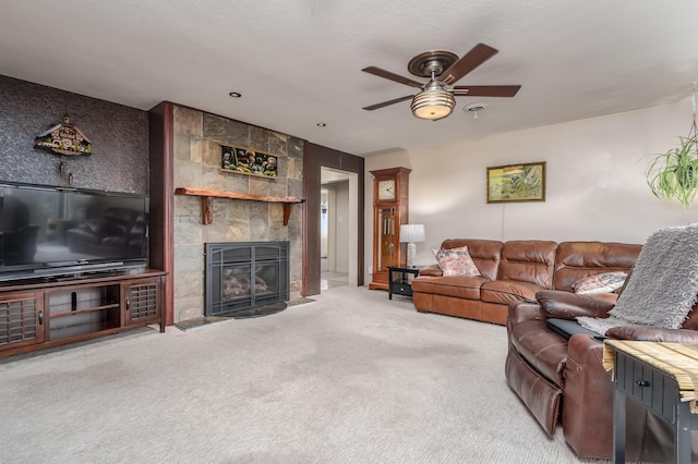 living room featuring carpet, ceiling fan, and a fireplace