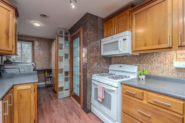 kitchen with hardwood / wood-style floors and white appliances