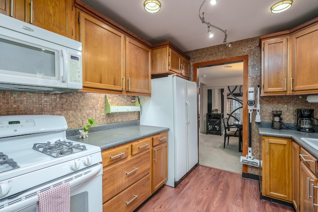 kitchen featuring tasteful backsplash, dark hardwood / wood-style floors, and white appliances