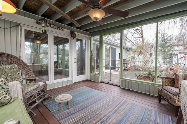 sunroom featuring beam ceiling and ceiling fan