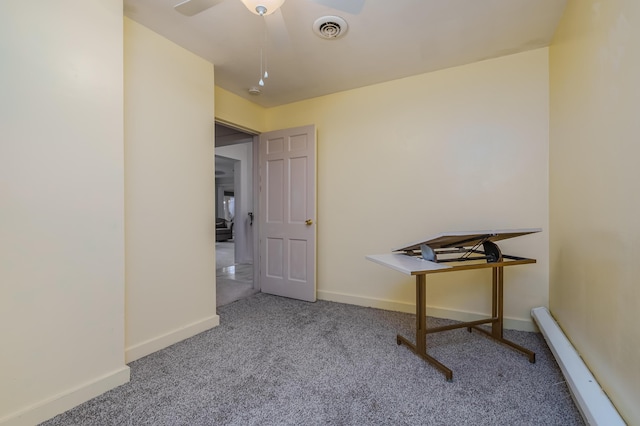 unfurnished office featuring carpet flooring, ceiling fan, and a baseboard radiator