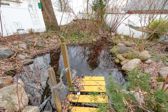 view of yard featuring a garden pond