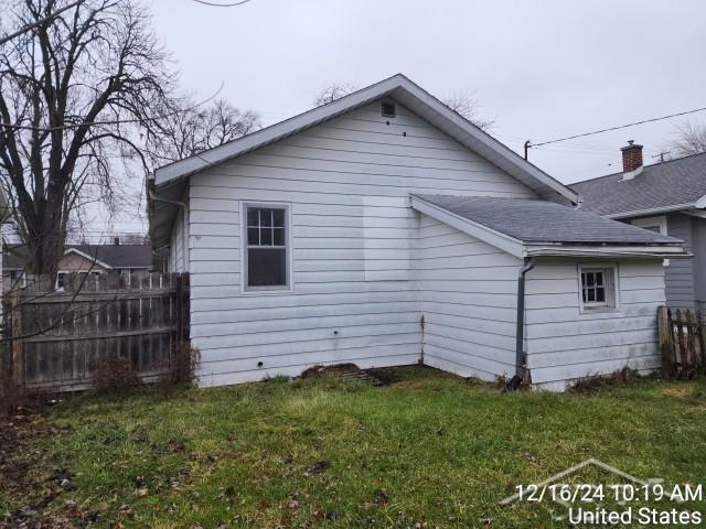 view of property exterior with a lawn