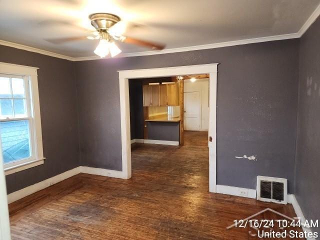 spare room featuring dark hardwood / wood-style floors, ceiling fan, and ornamental molding