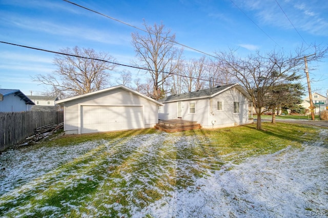 view of home's exterior featuring a garage, an outdoor structure, and a yard