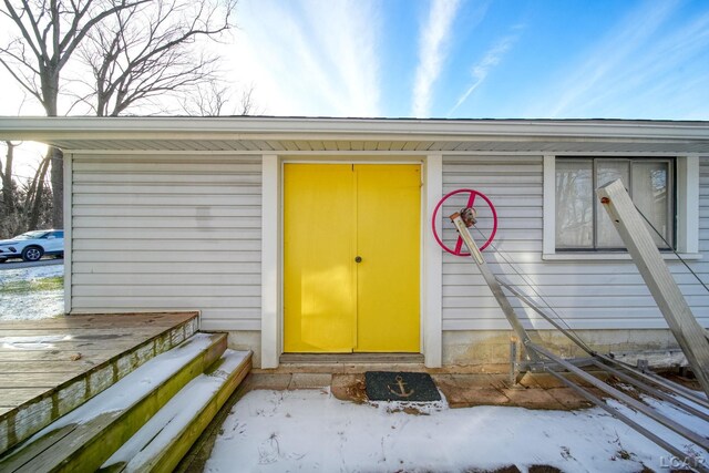 view of snow covered property entrance