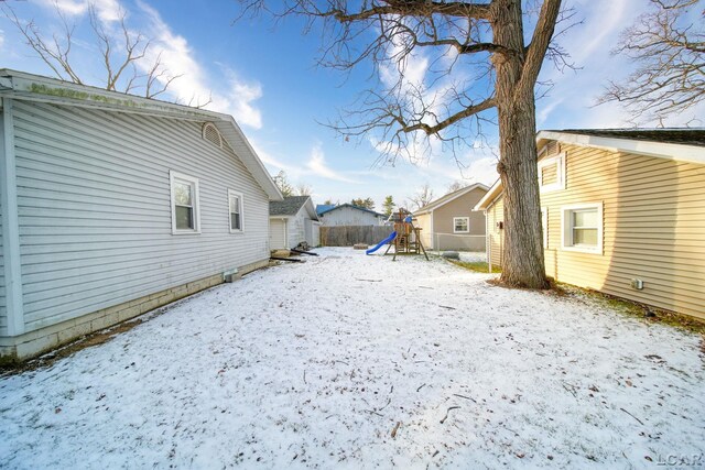 snowy yard with a playground