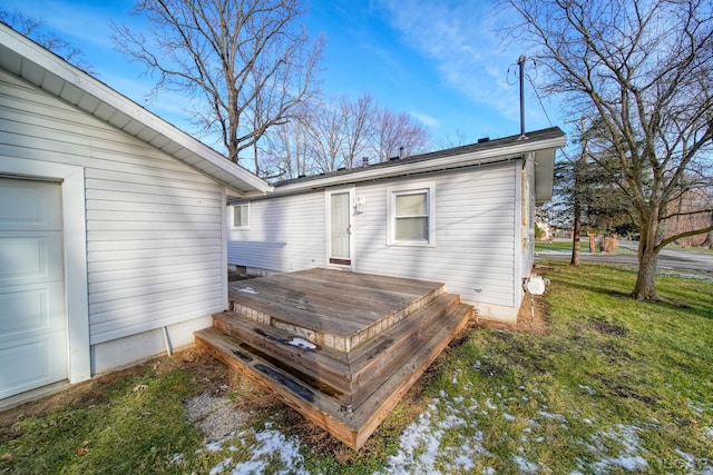 rear view of property featuring a deck and a yard