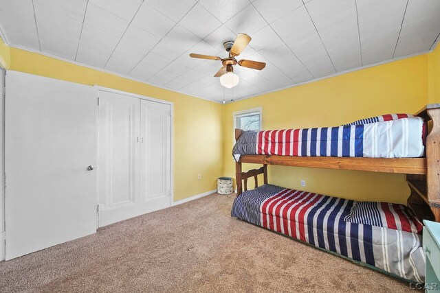 bedroom featuring carpet, ceiling fan, and ornamental molding