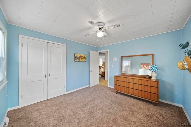 bedroom featuring carpet flooring, ceiling fan, and a closet