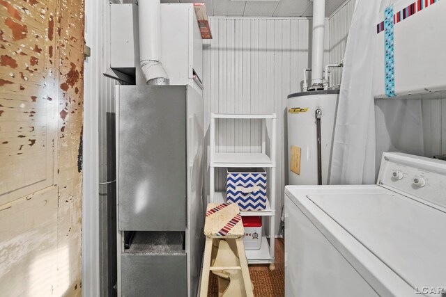 clothes washing area with water heater and washer / dryer