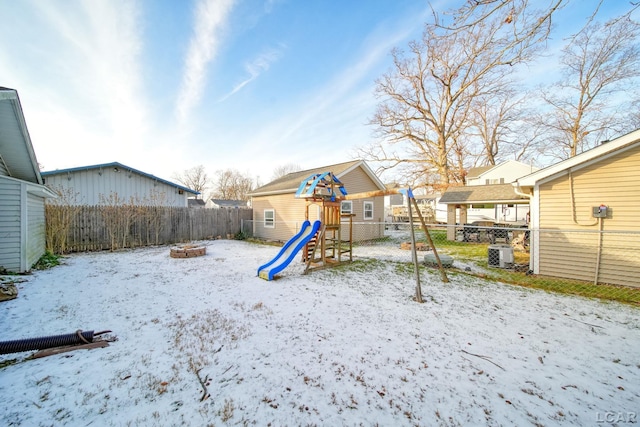 snow covered playground featuring an outdoor fire pit