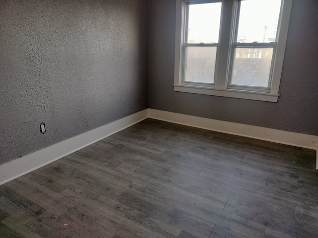 spare room with dark wood-type flooring