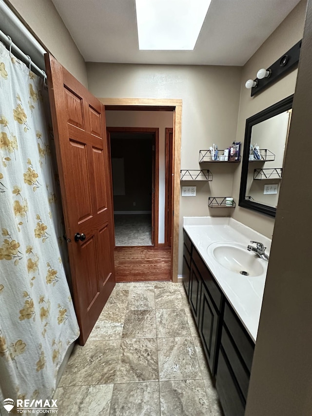 bathroom with vanity and a skylight