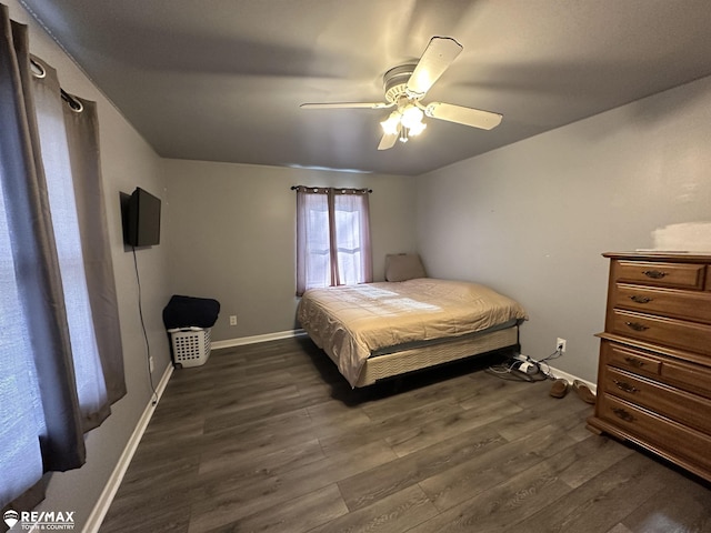 bedroom with dark hardwood / wood-style flooring and ceiling fan