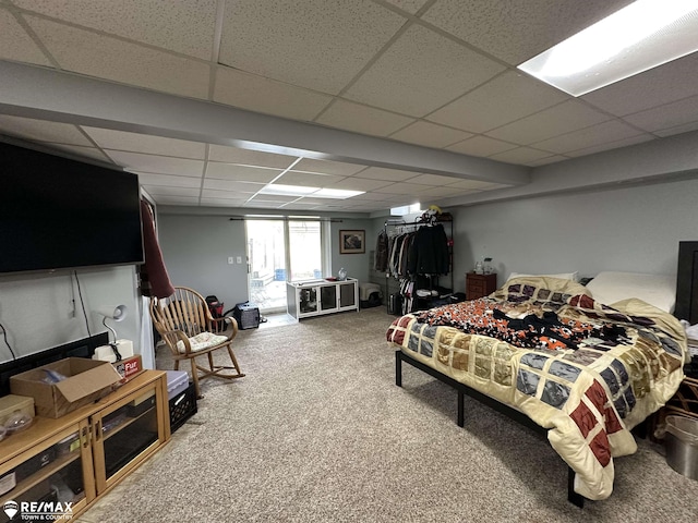 carpeted bedroom featuring a paneled ceiling