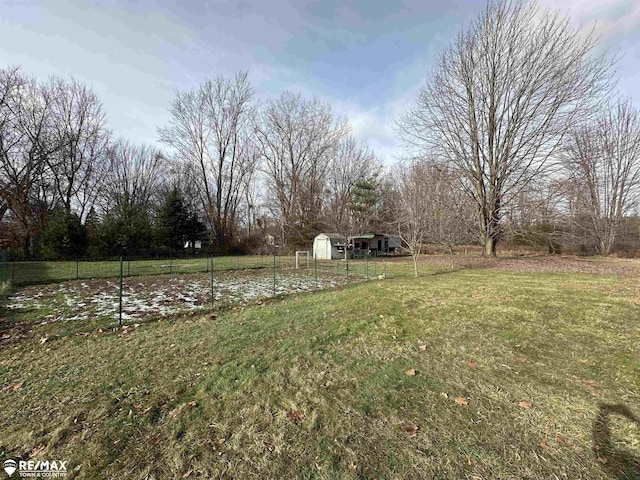 view of yard with a rural view and a storage unit