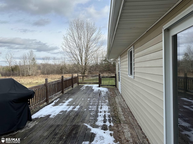 snow covered deck featuring a grill