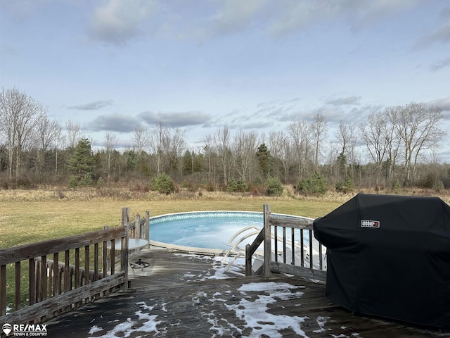 view of pool featuring grilling area and a lawn