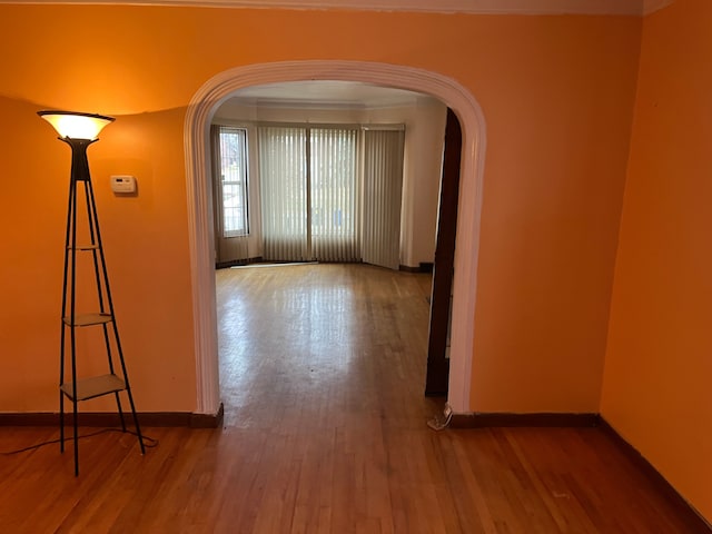 hall featuring hardwood / wood-style floors and crown molding