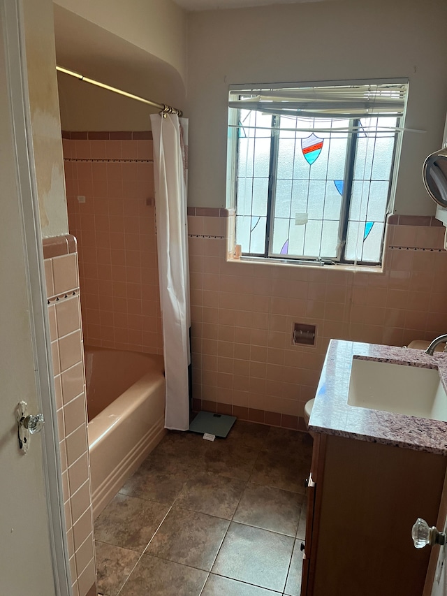 bathroom featuring vanity, tile patterned floors, tile walls, and shower / bath combo with shower curtain