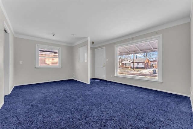 carpeted empty room featuring a wealth of natural light and crown molding