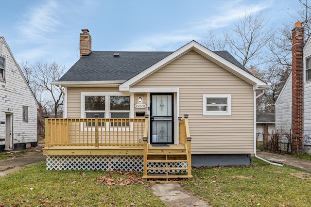 back of house featuring a yard and a wooden deck