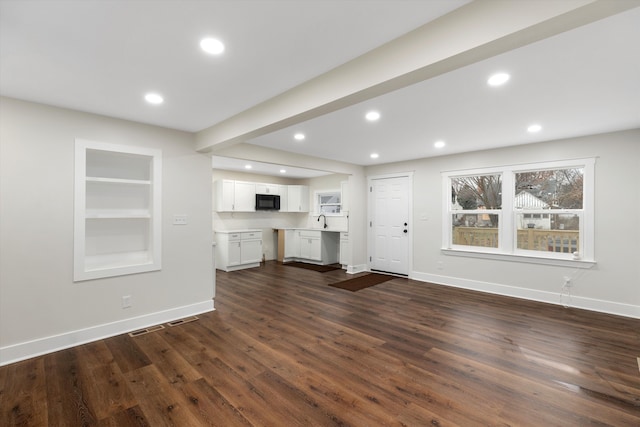 unfurnished living room with sink and dark wood-type flooring