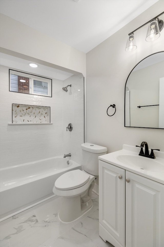 full bathroom featuring tiled shower / bath combo, toilet, and vanity