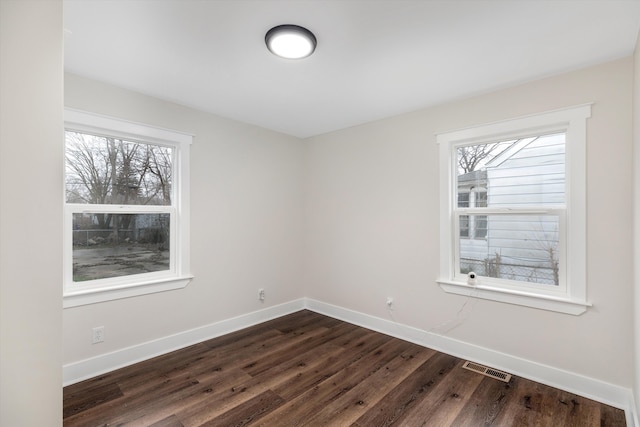 spare room with dark hardwood / wood-style floors