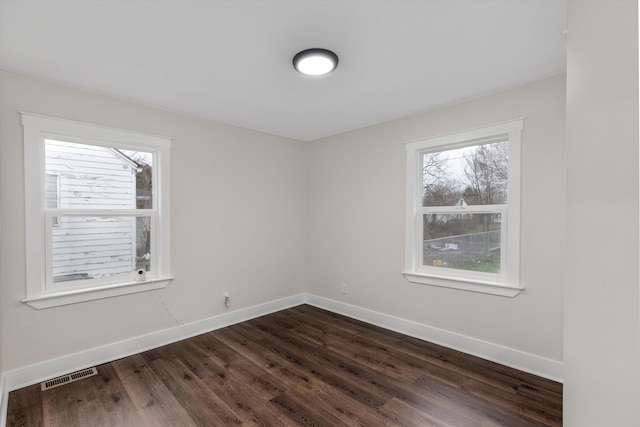 empty room featuring dark wood-type flooring