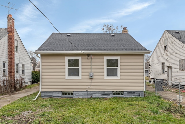 back of house with a lawn