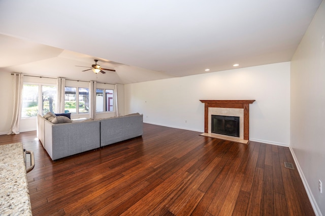 unfurnished living room with ceiling fan and dark hardwood / wood-style floors