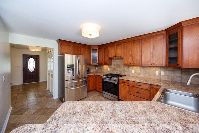 kitchen with stainless steel appliances, tasteful backsplash, and sink