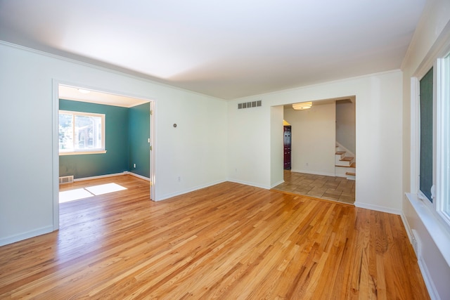 unfurnished room featuring crown molding and light hardwood / wood-style floors