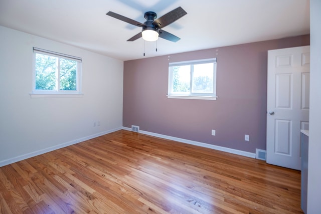 unfurnished room featuring ceiling fan, a healthy amount of sunlight, and light hardwood / wood-style floors