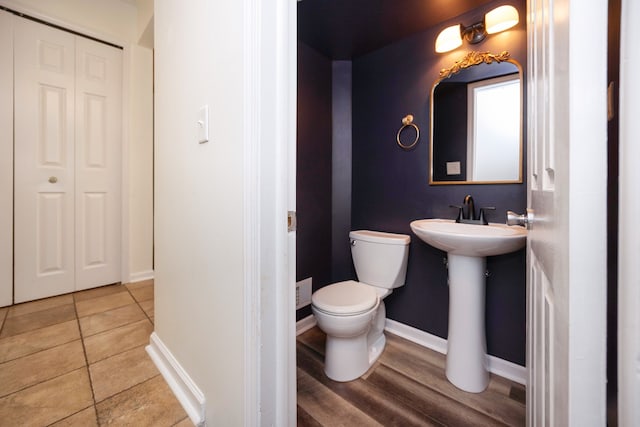 bathroom featuring hardwood / wood-style floors and toilet