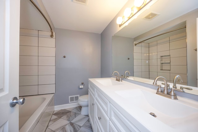 full bathroom featuring tiled shower / bath, vanity, and toilet