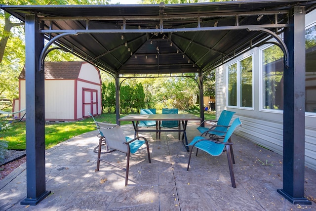 view of patio featuring a gazebo and a shed