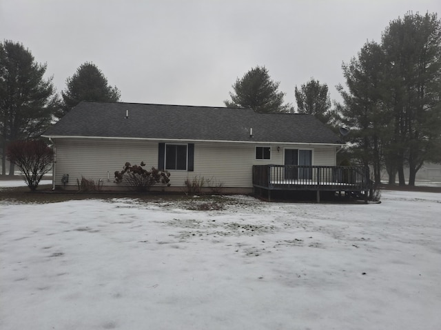 snow covered house with a deck